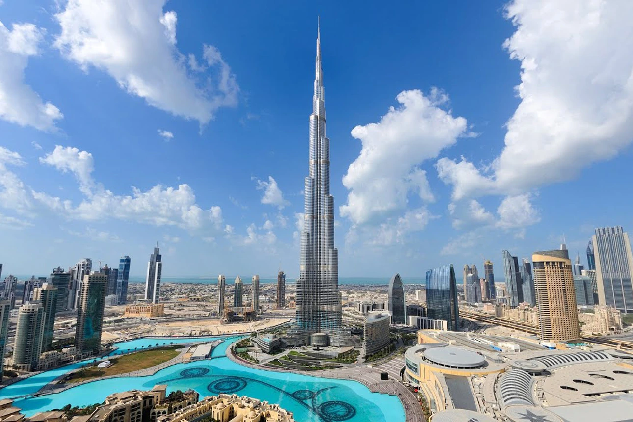 The Burj Khalifa piercing the clouds at sunset.