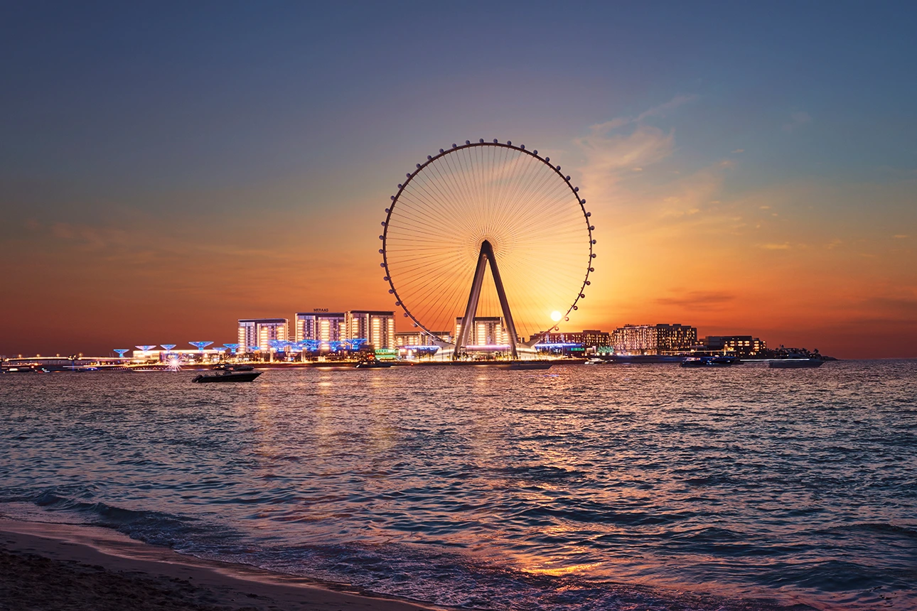 Sunny day at JBR beach with the city skyline in the background.
